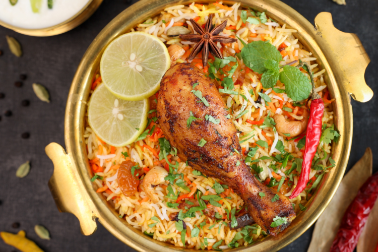 A tantalizing serving of Instant Pot Biryani, a classic Indian rice dish, presented in a white bowl. Fragrant basmati rice is beautifully layered with seasoned meat or vegetables, garnished with saffron-soaked milk, and sprinkled with fresh herbs. This aromatic dish embodies the rich and complex flavors of India.