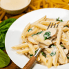 Delicious and creamy Instant Pot Chicken Alfredo served with a side of Caesar salad, creating a perfect balance of flavors. A gourmet meal ready in a flash!